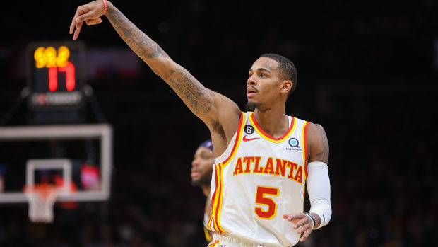 Hawks guard Dejounte Murray holds his form after making a shot.